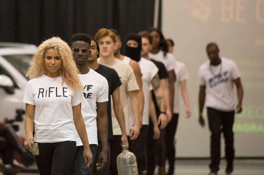 Models in t-shirts walking a runway