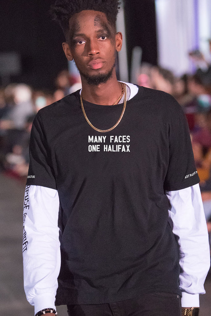 Many Faces One Halifax Tee, Black worn by a Black man on a fashion show runway