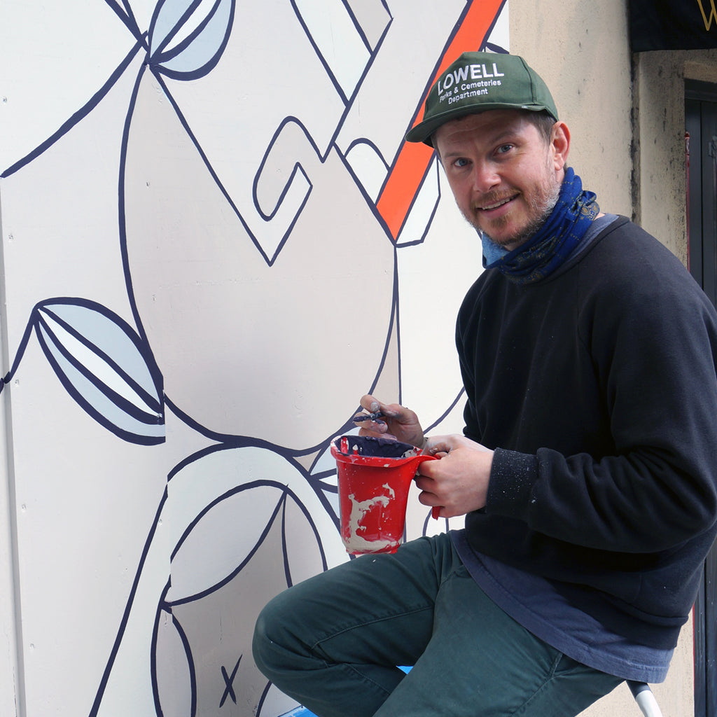 Photo of Jonathan Smith painting a mural
