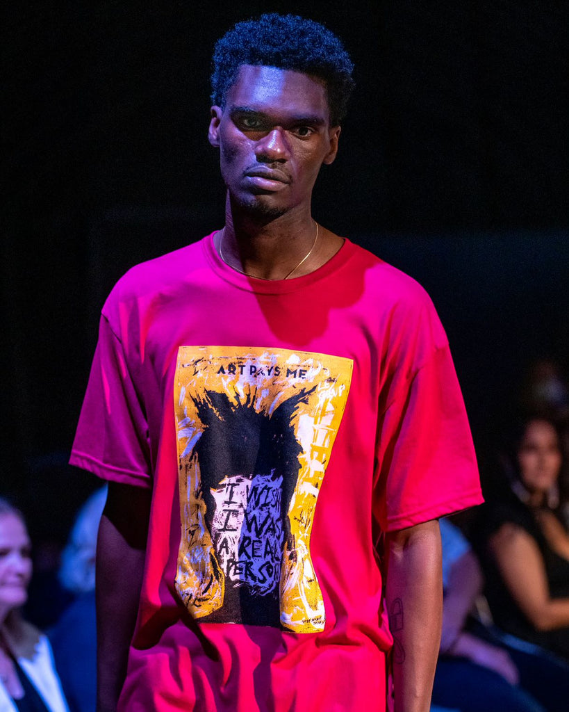 Arenye modelling a berry coloured t-shirt with a portrait of Jean-Michel Basquiat 