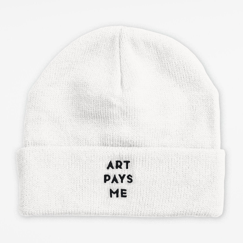 White toque with Art Pays Me embroidered in black thread