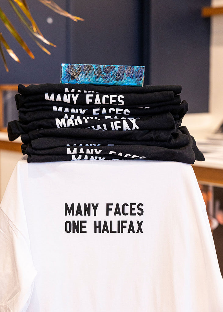 The black and white Many Faces One Halifax Tees at Halifax Shopping Centre during an Art Pays Me and HaliTube pop-up event. Photo by Emma Lomas.